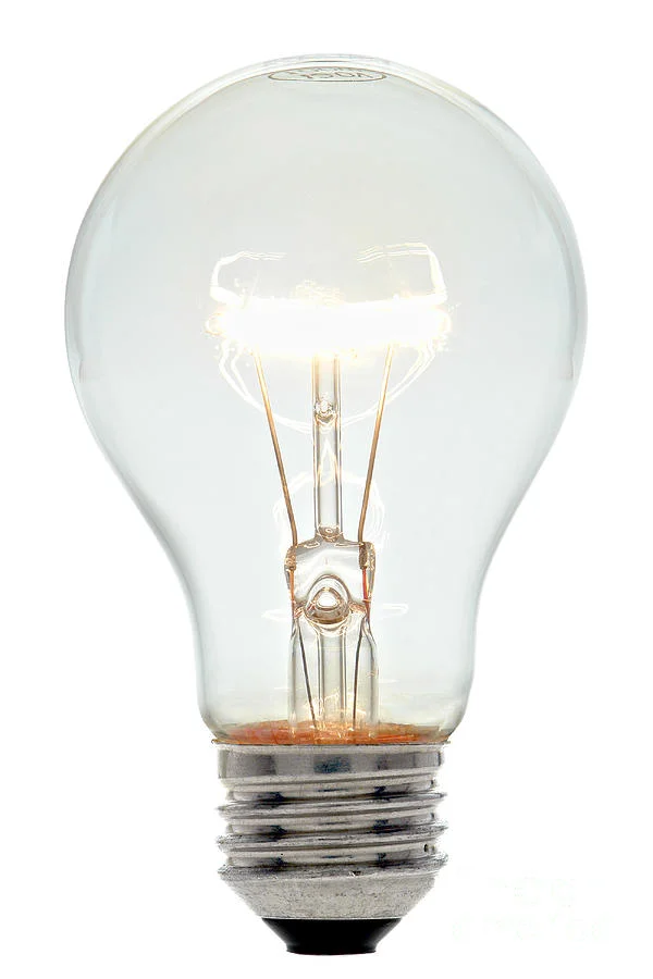 A glowing clear glass incandescent light bulb against a white background, warm filament glow suggesting a bright idea